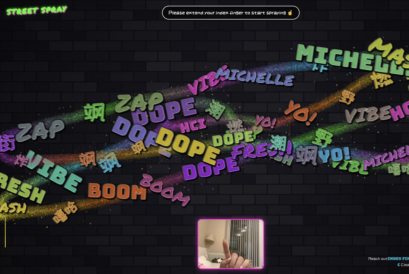 Wall with layered words while the webcam shows a raised index finger